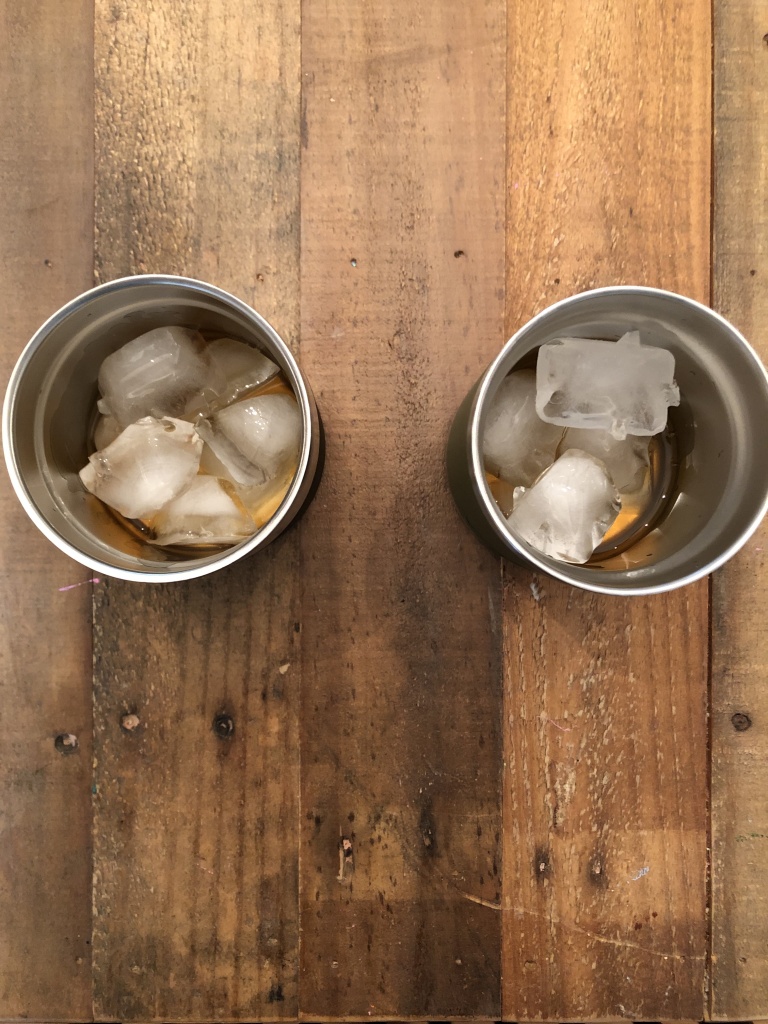 Whiskey and ice in Coleman and Yeti tumblers