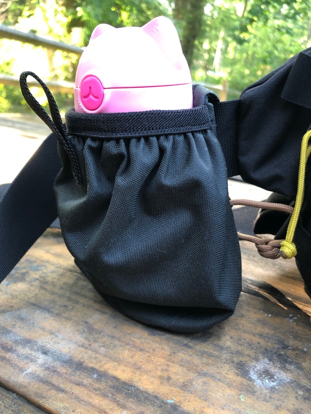 Close up of the Mystery Ranch Bottle Pocket attached to a Hip Monkey and held in place with Gear Aid Fire Strand 550 paracord