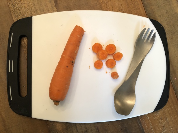 humangear GoBites Ti-Uno Titanium Spork cutting a carrot
