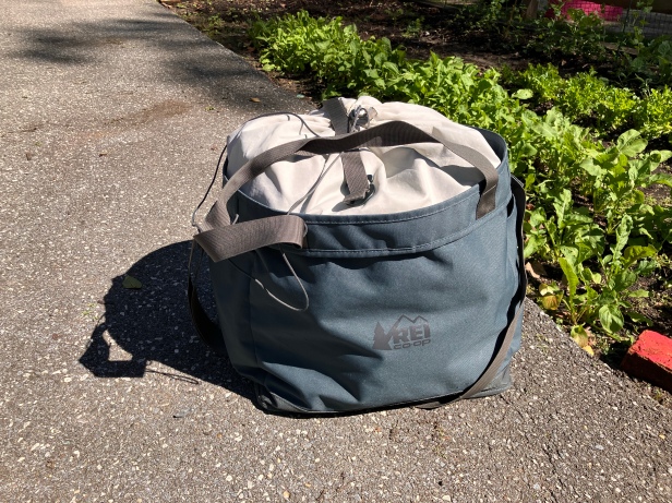 The REI Co-op Pack-Away 45 Tote on the ground, packed full